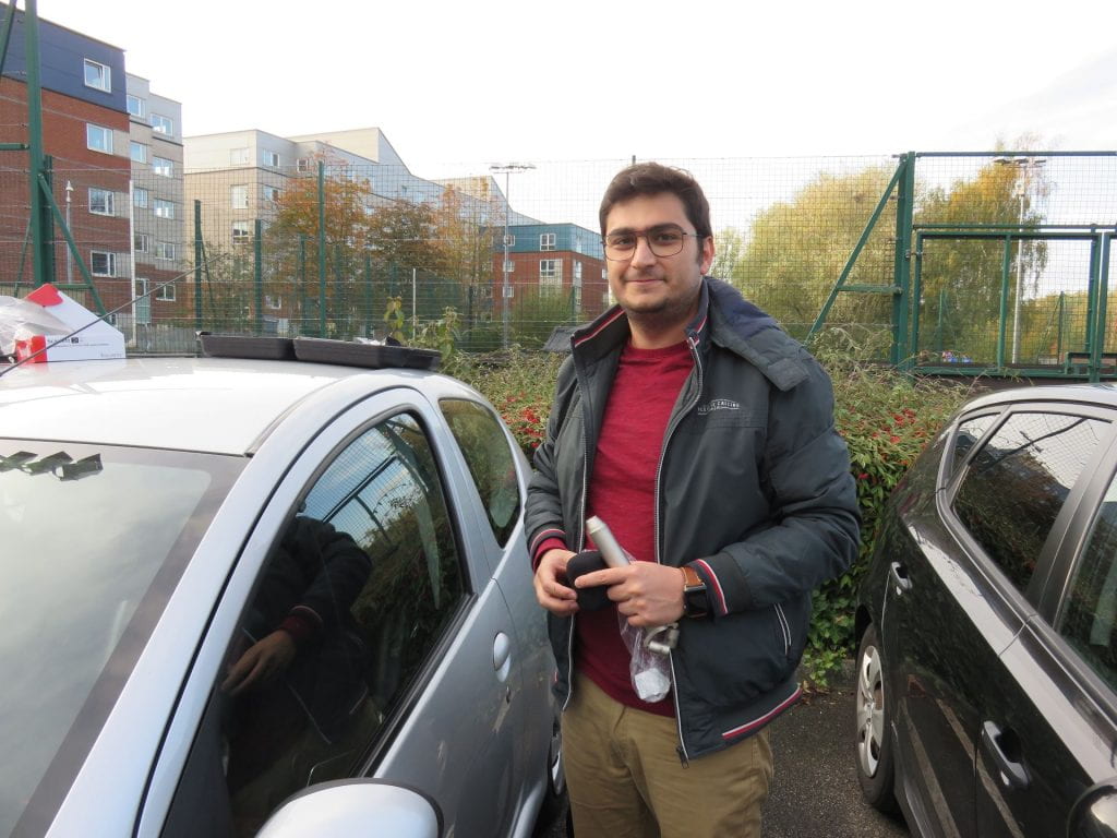 Siavash Bahrami standing by car